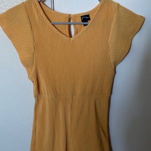 yellow jumpsuit that has a ripple effect